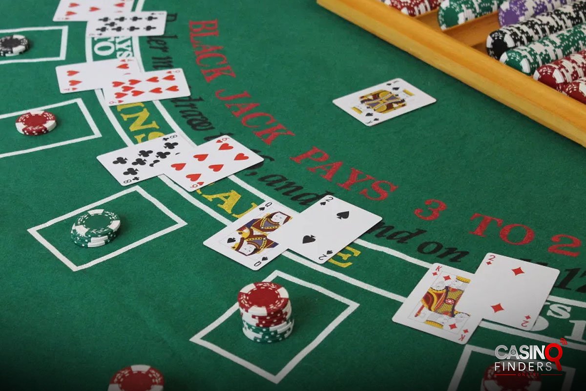 blackjack table with playing cards and chips | how to play blackjack with match play