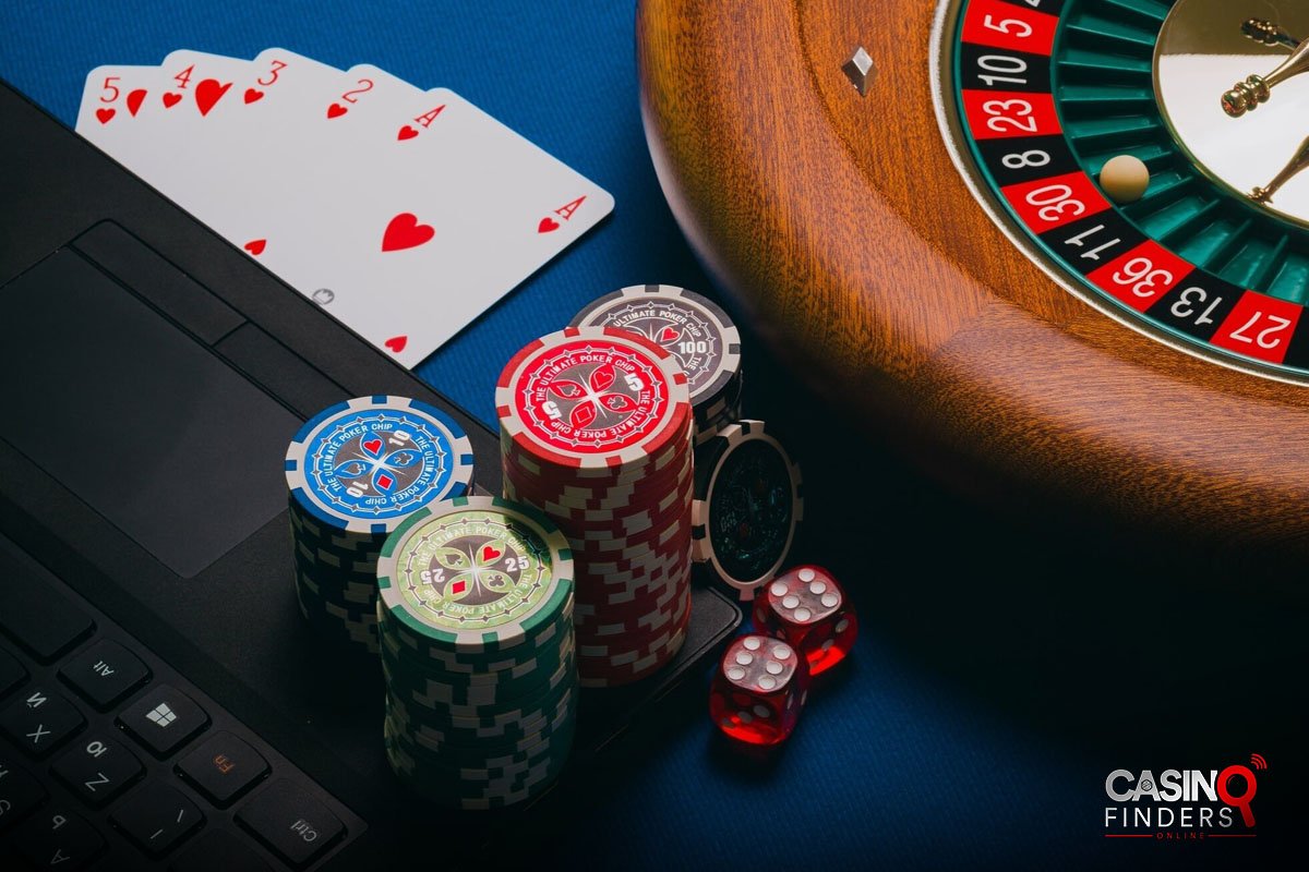 image featuring poker chips, playing cards, roulette wheel, dice, and lap top