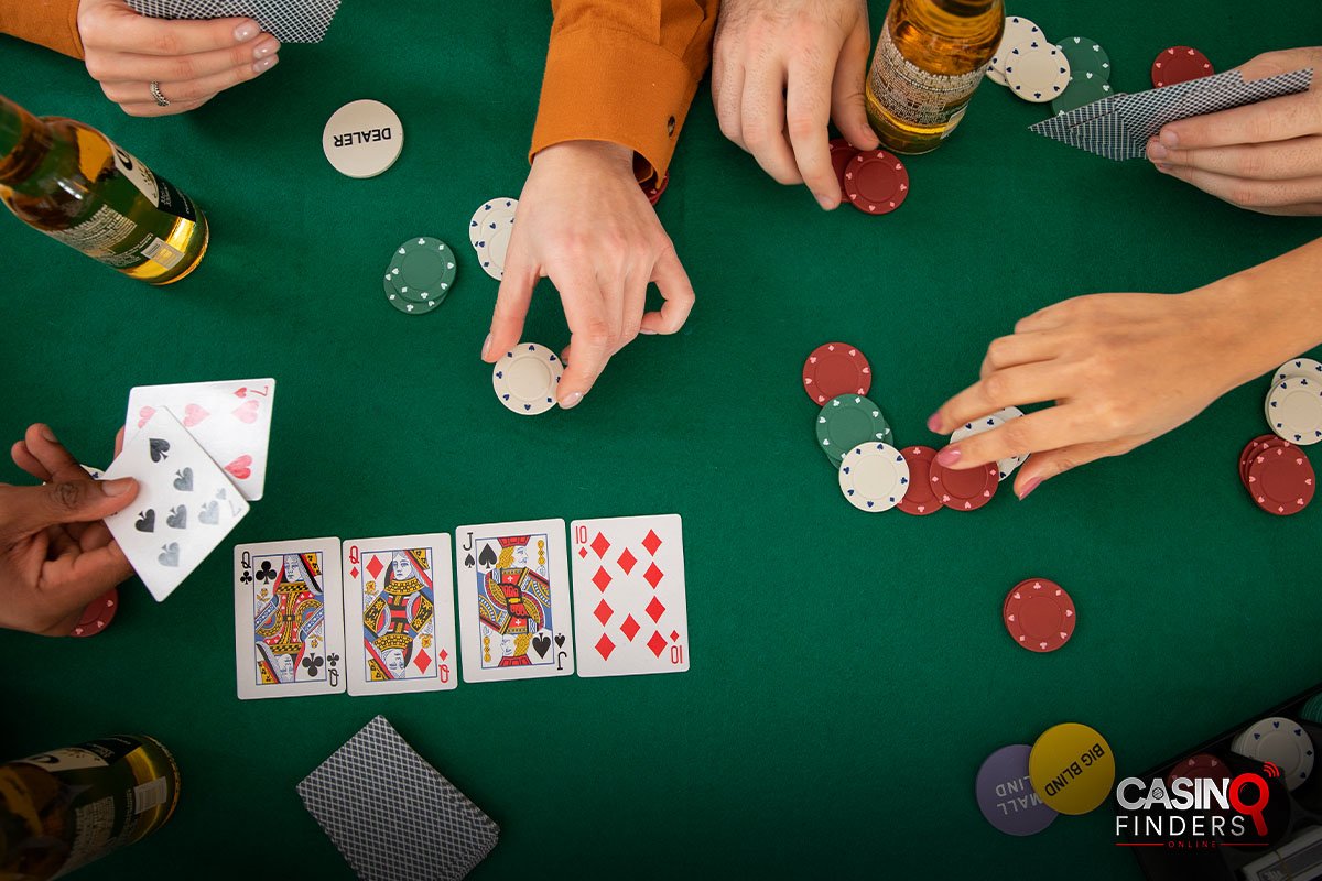 top view of hands playing poker with fake chips
